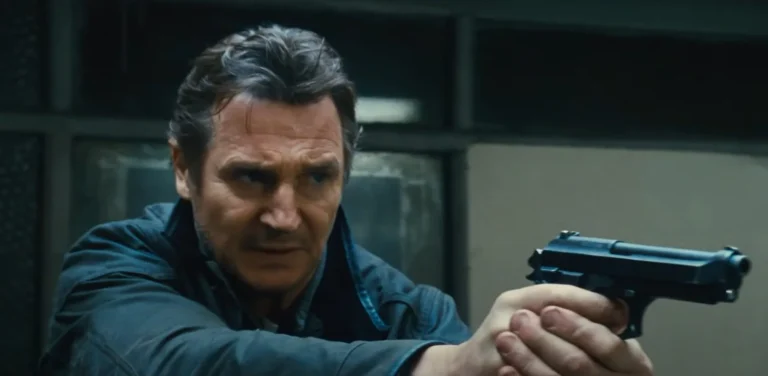 Liam Neeson holding a gun in Taken